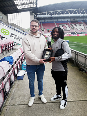 Dion Rankine receiving his away player of the match award