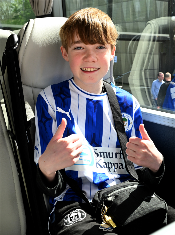 Young Wigan supporter giving the thumbs up
